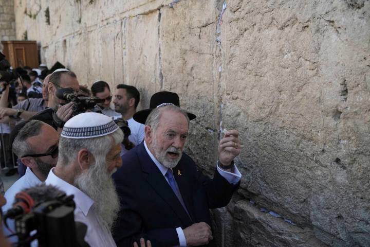 The US ambassador to Israel Mike Huckabee holds a note given to him from US President Donald Tr ...