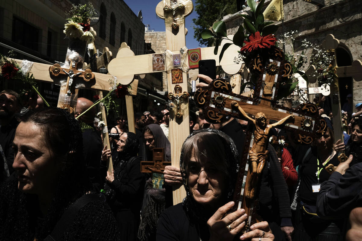 Christian pilgrims carry crosses during Good Friday procession in the Old City of Jerusalem on ...