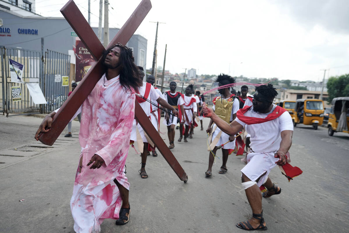 Members of the St Francis Catholic Church take part in a Way of the Cross re-enactment of the c ...