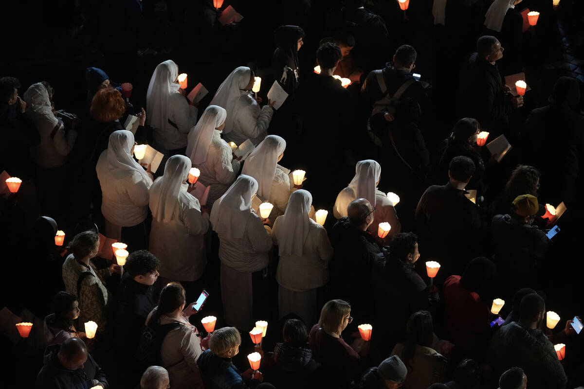 Nuns attend the procession outside the Colosseum during the Via Crucis (Latin for 'way of the c ...