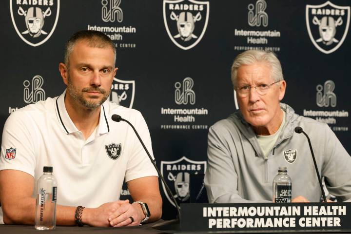 Raiders coach Pete Carroll and General Manager John Spytek listen to reporters questions during ...