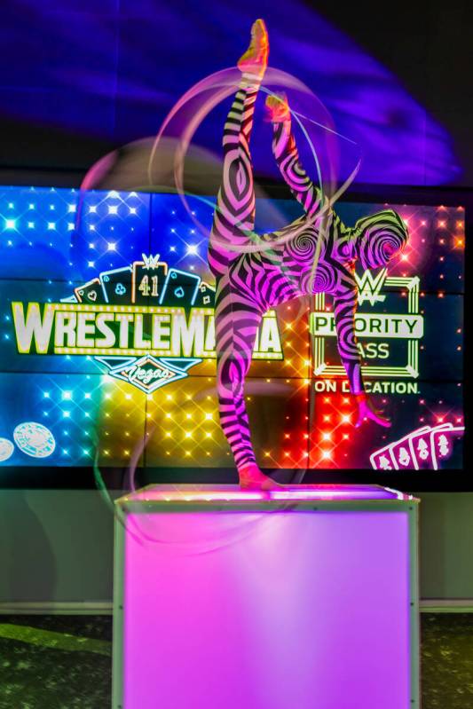 A performer twirls ribbons during a WrestleMania kickoff party hosted by experience/hospitality ...