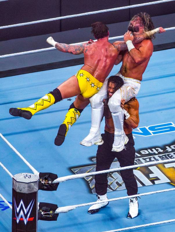 CM Punk leaps onto Seth Rollins atop the shoulders of Roman Reigns in the final match at Wrestl ...