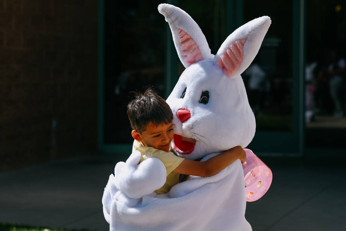 Holden Cotta, 4, hugs the Easter Bunny during a community egg hunt hosted by Commissioner Jim G ...