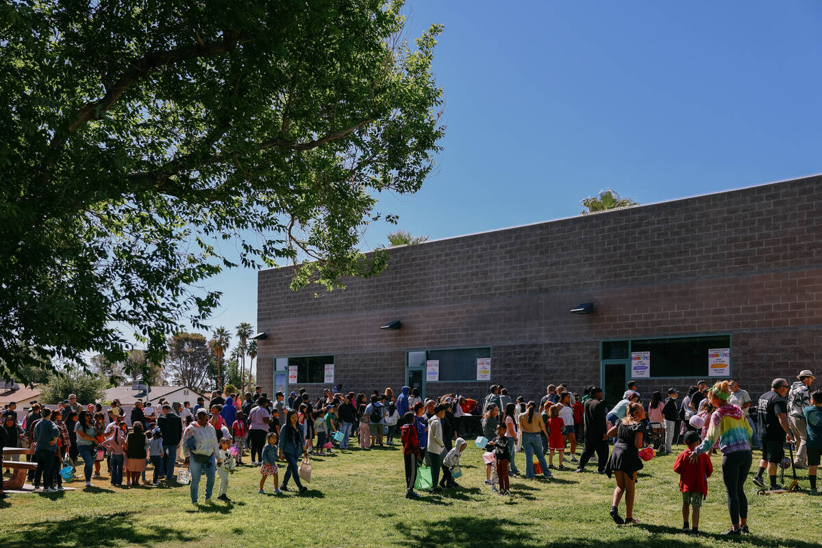 Families line up to sign in for the community egg hunt hosted by Commissioner Jim Gibson and Cl ...