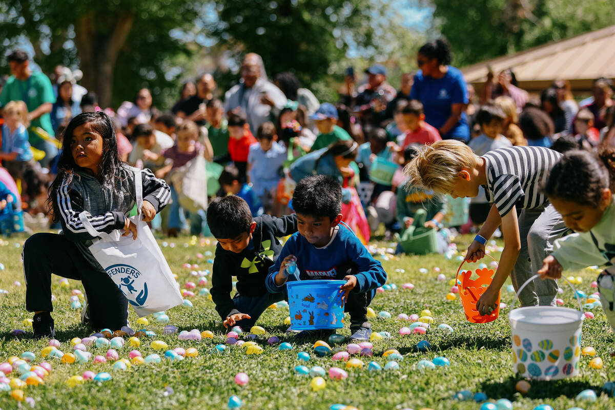 Children crouch down to hastily fill their baskets with eggs during the annual community egg hu ...