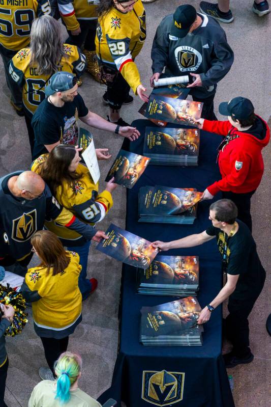 Fans enter the arena and receive Mark Stone posters as the Golden Knights will face the Minneso ...