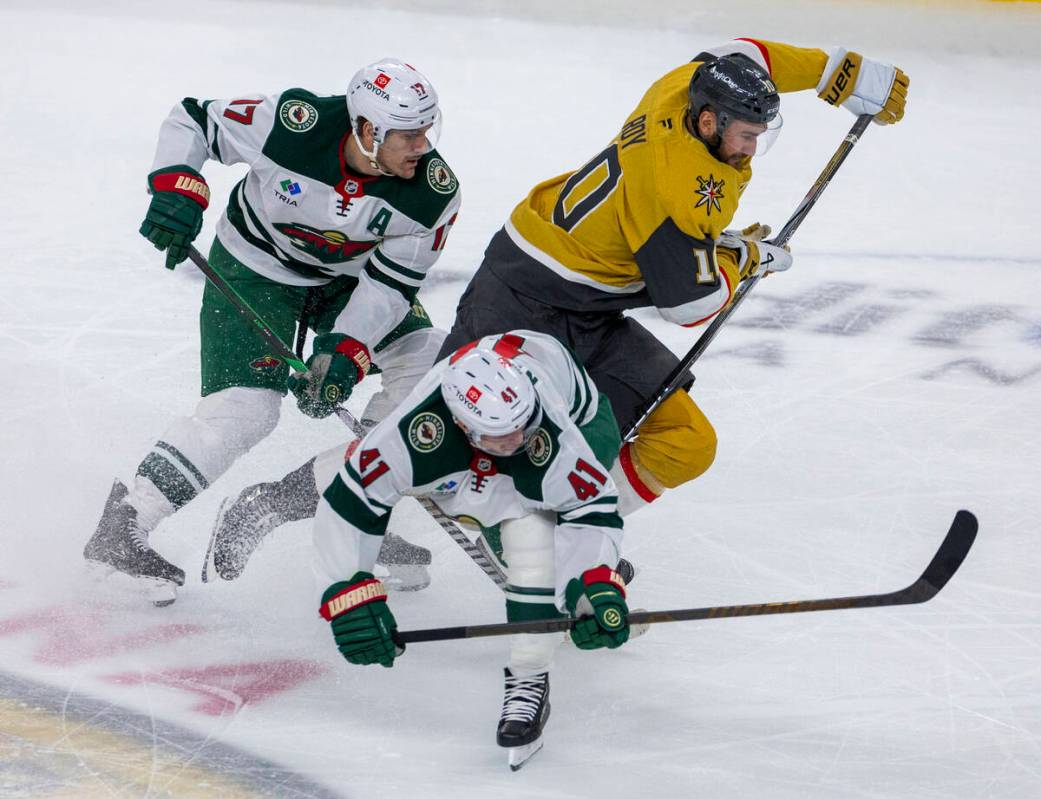 Golden Knights center Nicolas Roy (10) collides with Minnesota Wild center Gustav Nyquist (41) ...