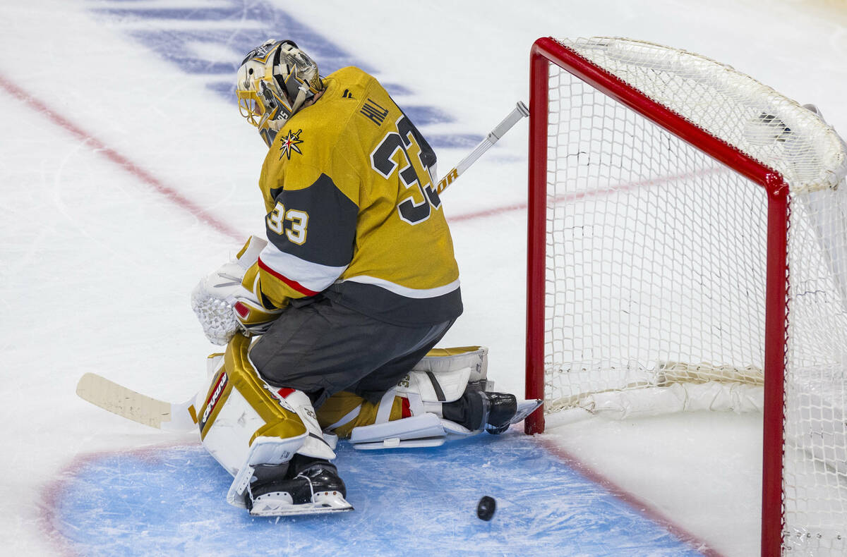 A puck from the Minnesota Wild gets past Golden Knights goaltender Adin Hill (33) during the f ...