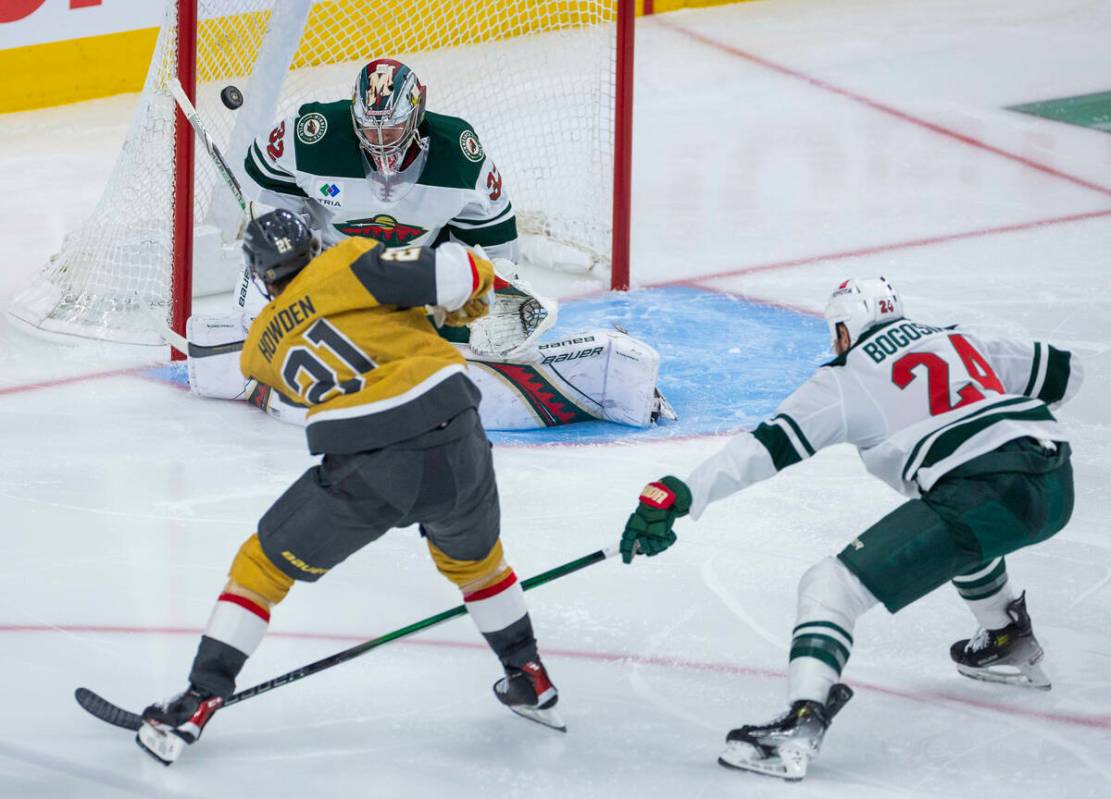 Golden Knights center Brett Howden (21) scores against Minnesota Wild goaltender Filip Gustavss ...