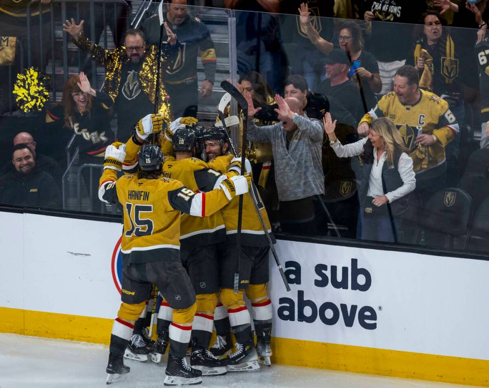 Golden Knights players celebrate a score against Minnesota Wild goaltender Filip Gustavsson (32 ...