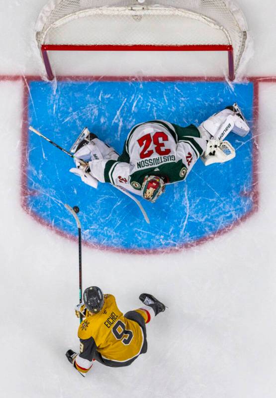 Golden Knights center Jack Eichel (9) looks to score against Minnesota Wild goaltender Filip Gu ...