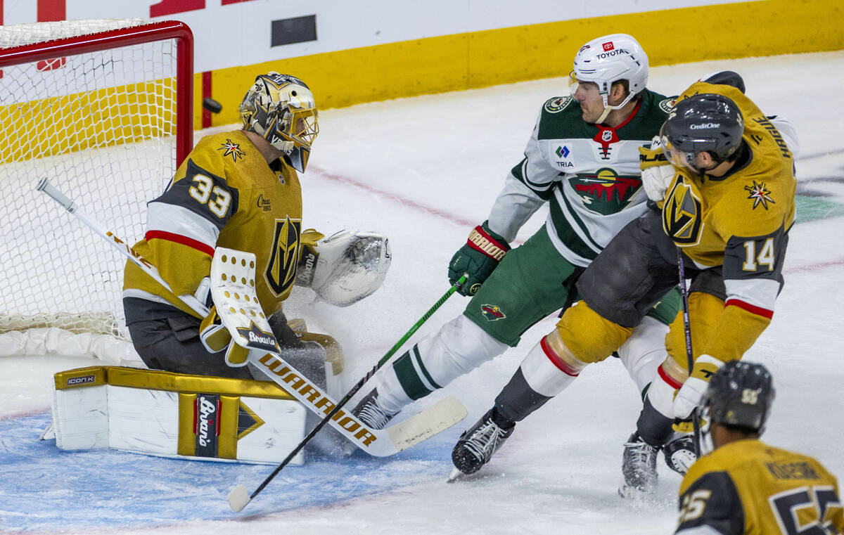 The puck goes just wide of Golden Knights goaltender Adin Hill (33) as Minnesota Wild left wing ...
