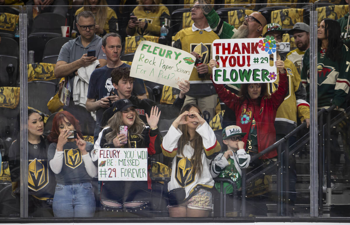 Golden Knights fans hold up signs and wave to former Knight and current Minnesota Wild goaltend ...