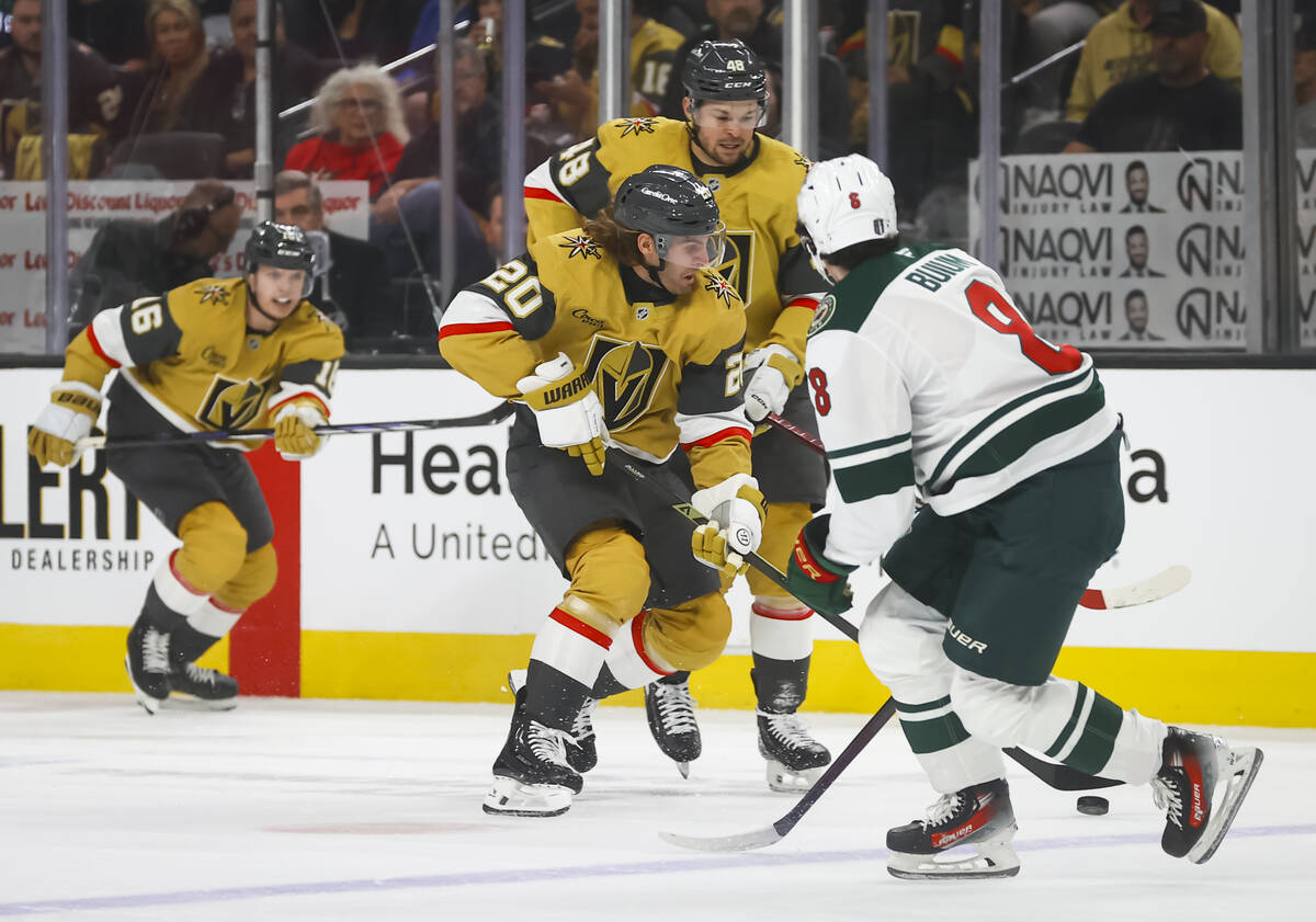 Golden Knights left wing Brandon Saad (20) skates with the puck in front of Minnesota Wild defe ...