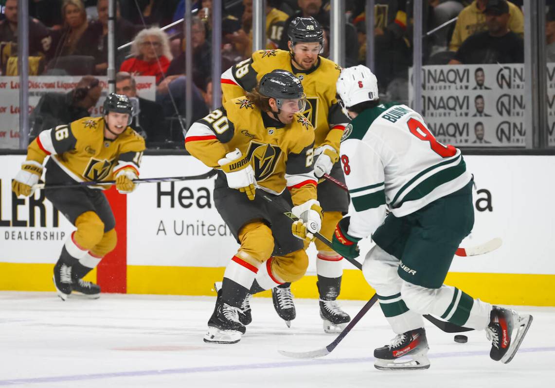 Golden Knights left wing Brandon Saad (20) skates with the puck in front of Minnesota Wild defe ...