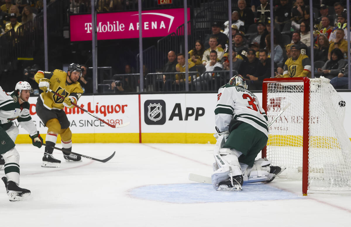 Golden Knights center Tomas Hertl (48) gets the puck past Minnesota Wild goaltender Filip Gusta ...