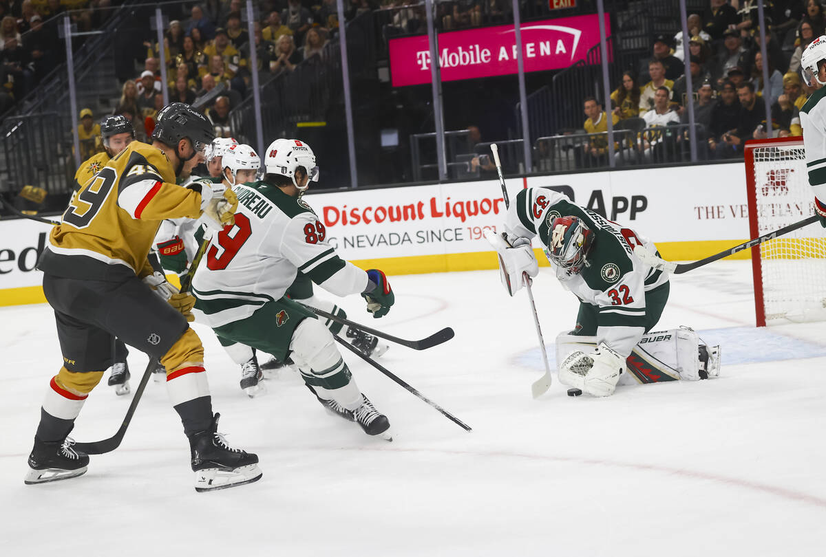 Minnesota Wild goaltender Filip Gustavsson (32) stops a shot from Golden Knights center Ivan Ba ...