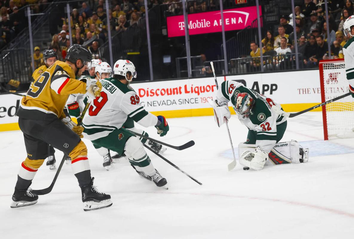Minnesota Wild goaltender Filip Gustavsson (32) stops a shot from Golden Knights center Ivan Ba ...