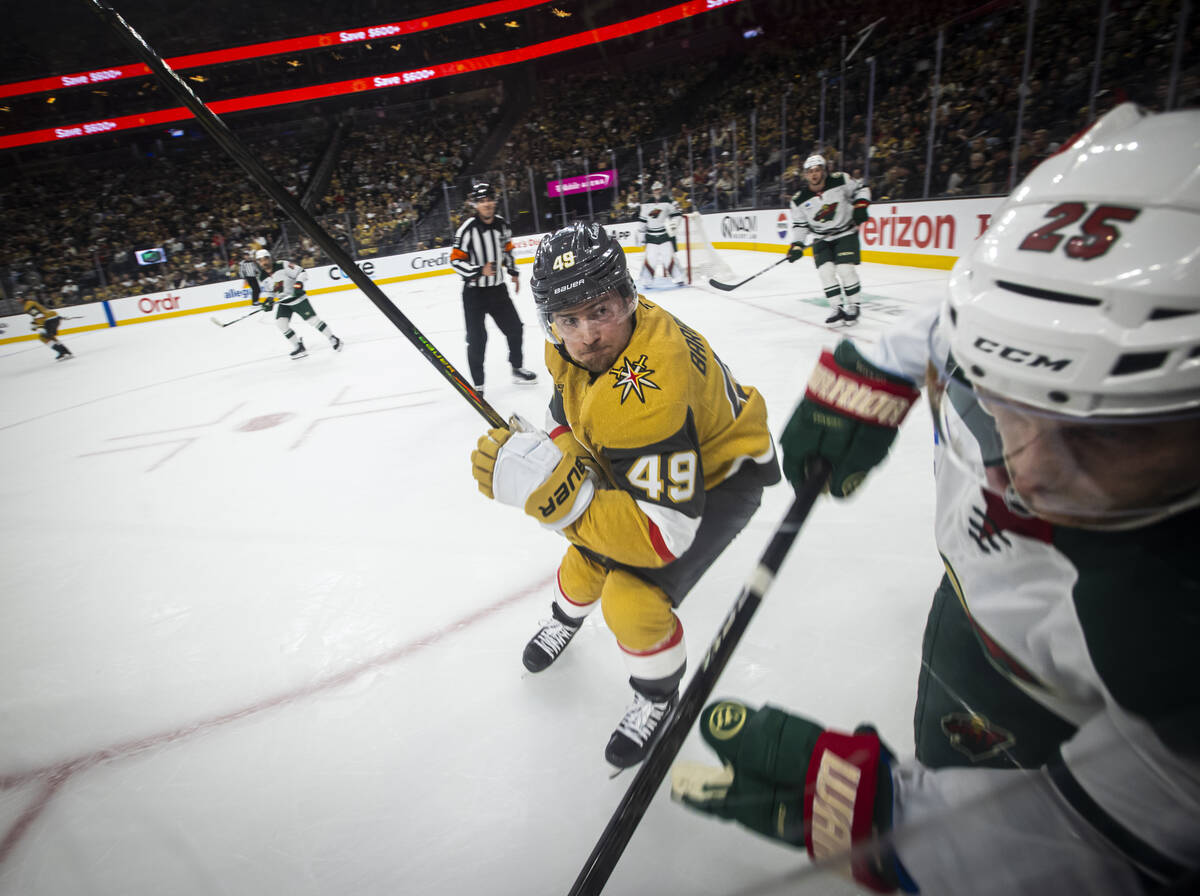 Golden Knights center Ivan Barbashev (49) looks to take Minnesota Wild defenseman Jonas Brodin ...