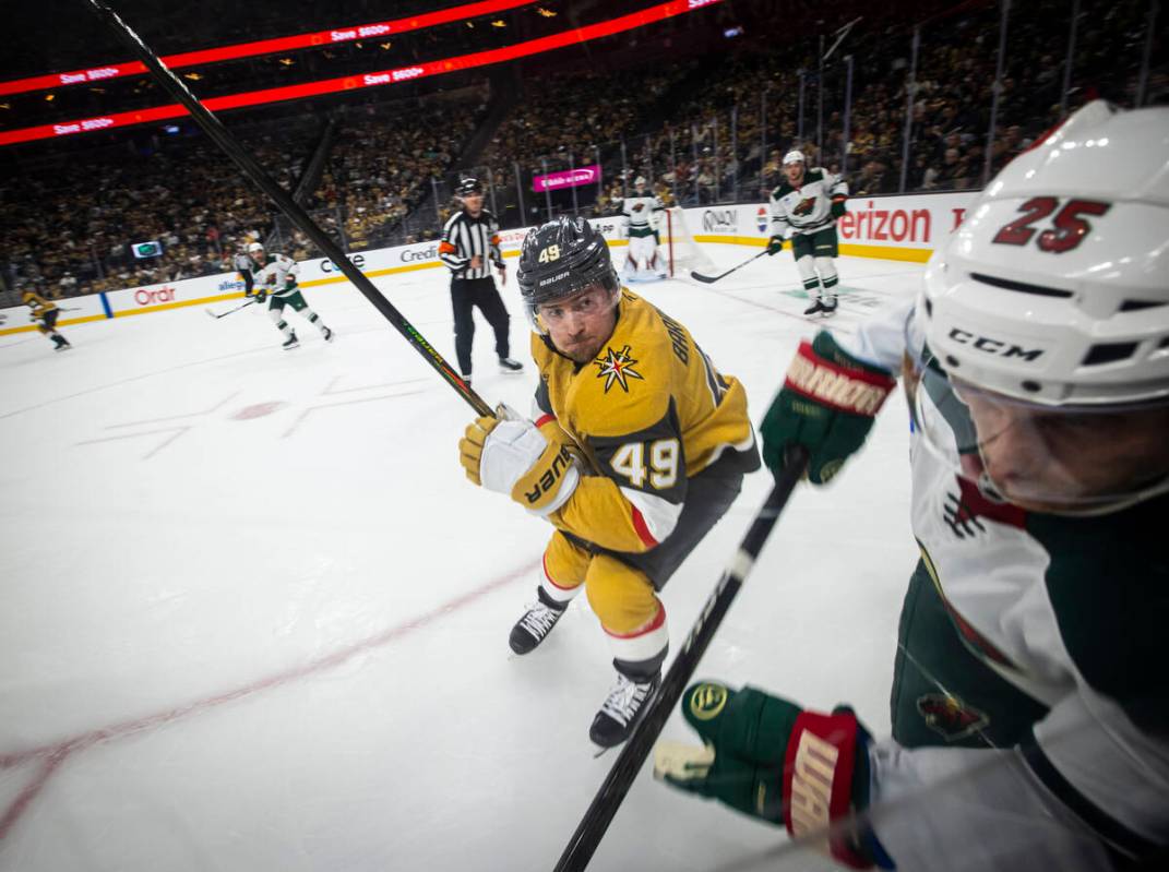 Golden Knights center Ivan Barbashev (49) looks to take Minnesota Wild defenseman Jonas Brodin ...