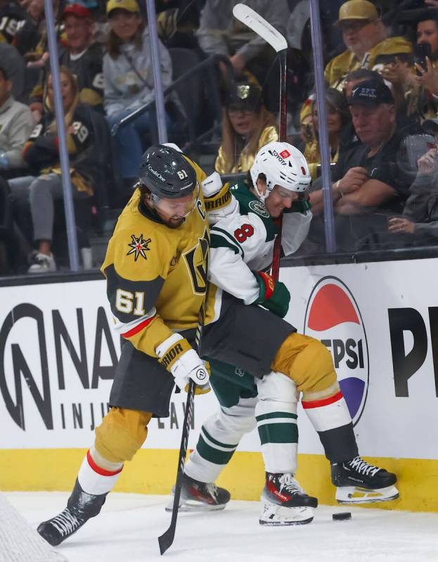 Golden Knights right wing Mark Stone (61) battles for control of the puck against Minnesota Wil ...