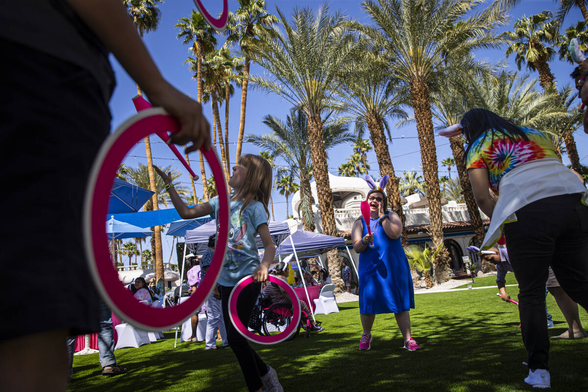 Children try juggling during an Easter celebration for members of the Down Syndrome Organizatio ...