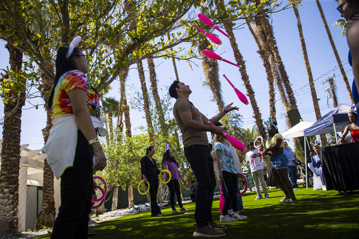 Juggler Rolando Bells, of Las Vegas, entertains children during an Easter celebration for membe ...