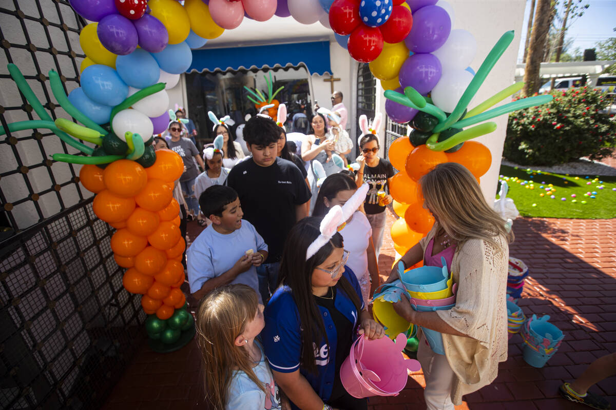 Easter baskets for an egg hunt are handed out during an Easter celebration for members of the D ...