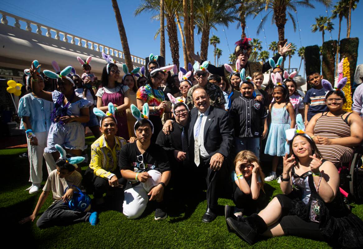 George Carden, center, and his wife, Alexandra Carden, lower left, pose with attendees during a ...