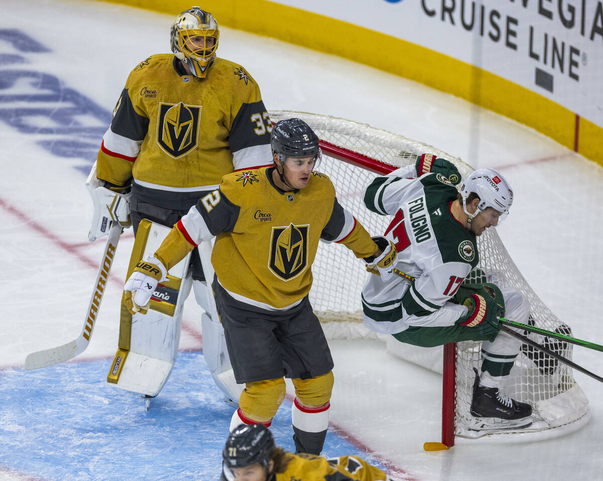 Minnesota Wild left wing Marcus Foligno (17) gets caught up in the net as he holds the stick of ...