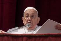 Pope Francis appears on the central lodge of St. Peter's Basilica to bestow the Urbi et Orbi (L ...