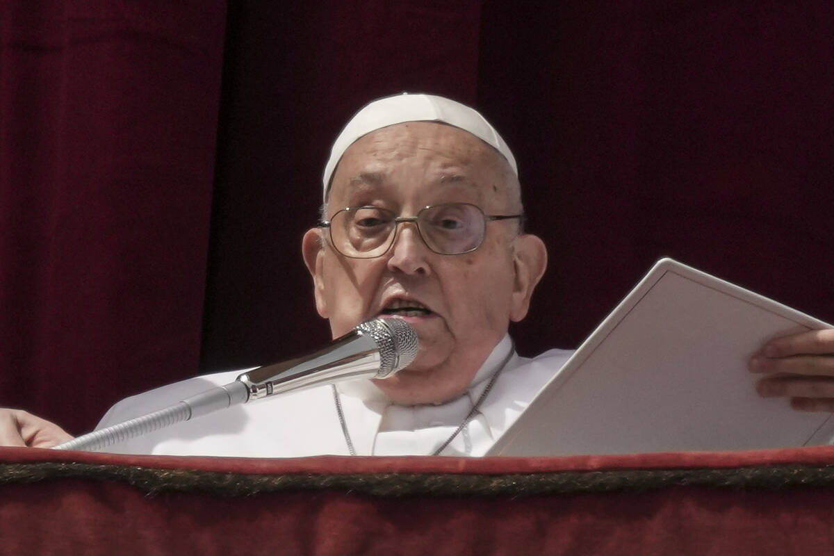 Pope Francis appears on the central lodge of St. Peter's Basilica to bestow the Urbi et Orbi (L ...