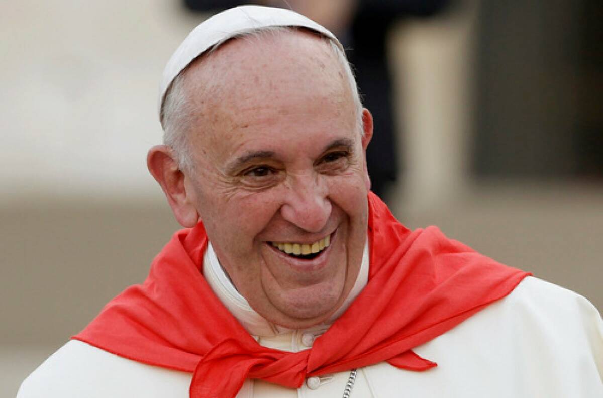 Pope Francis wears a red scarf as he smiles while leaving St. Peter's Square at the Vatican aft ...