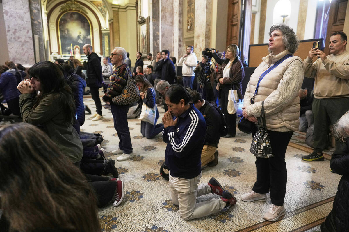 Worshippers pray during Mass at the Cathedral in Buenos Aires, Argentina, following the Vatican ...