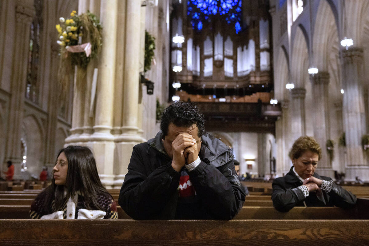 Parishioners pray at St. Patrick's Cathedral, Monday, April 21, 2025, in New York. (AP Photo/Yu ...