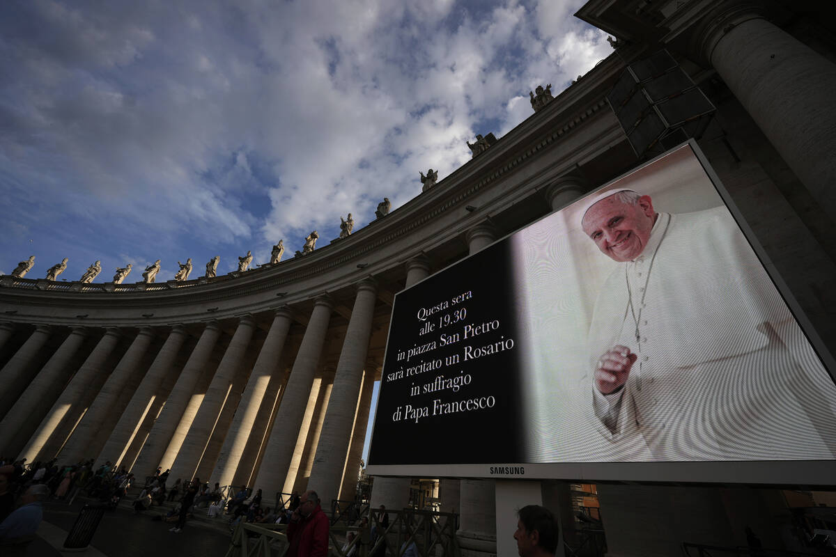 A giant screen announces a rosary prayer for the late Pope Francis in St. Peter's Square at the ...