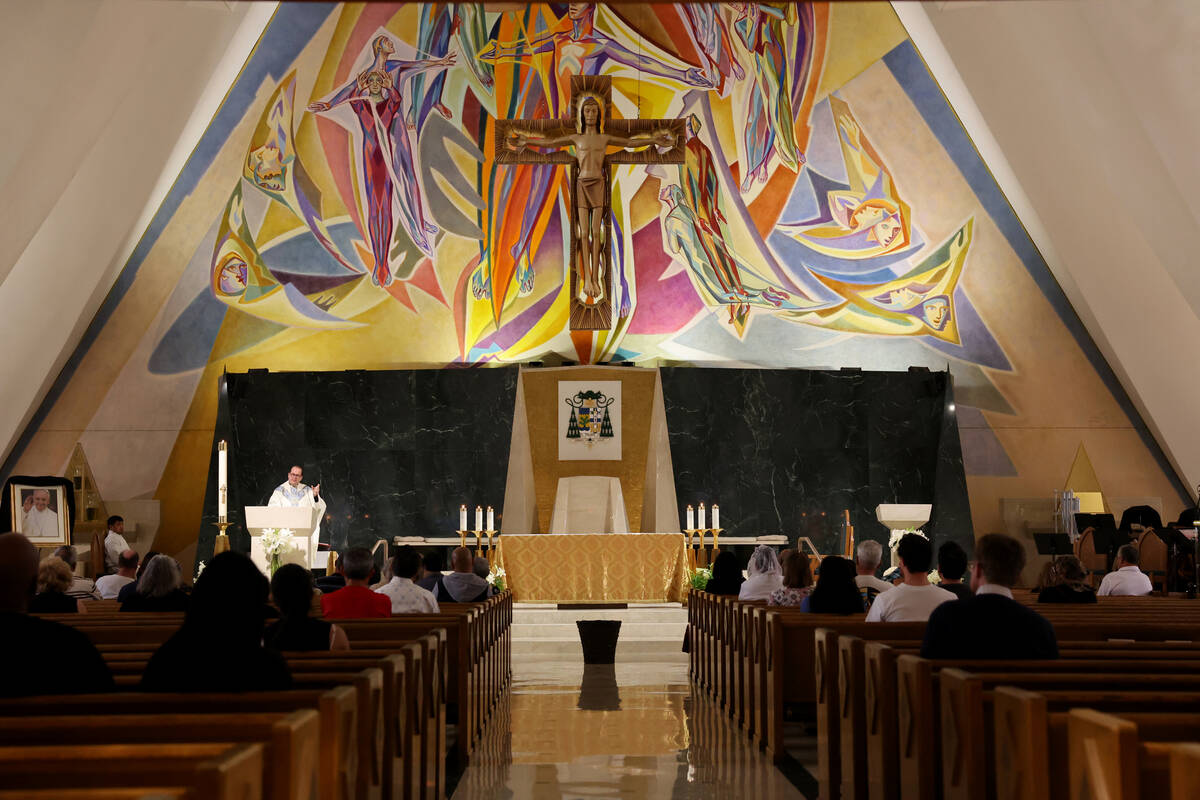 A photo of Pope Francis, who died at the age of 88, is shown draped in black blunting during ma ...