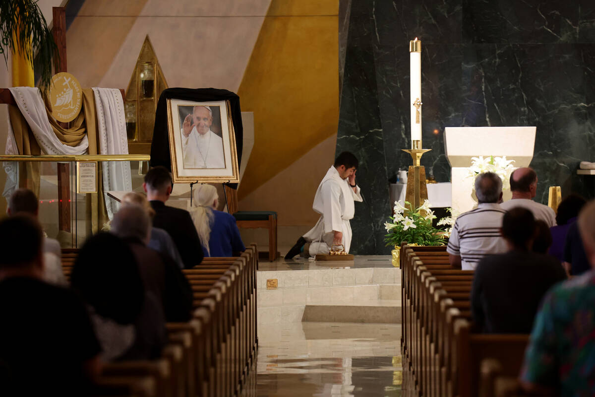 A photo of Pope Francis, who died at the age of 88, is shown draped in black blunting during ma ...
