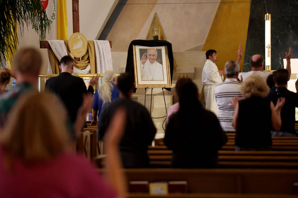 A photo of Pope Francis, who died at the age of 88, is shown draped in black blunting during ma ...