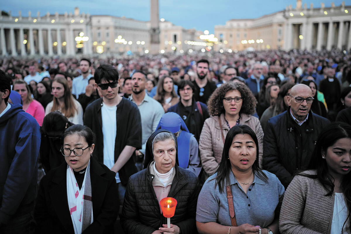 Faithful gather for a rosary prayer for the late Pope Francis, in St. Peter's Square at the Vat ...