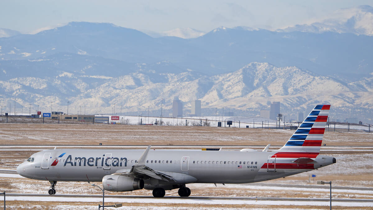 An American Airlines jetliner rumbles down a runway at Denver International Airport, Jan. 16, 2 ...