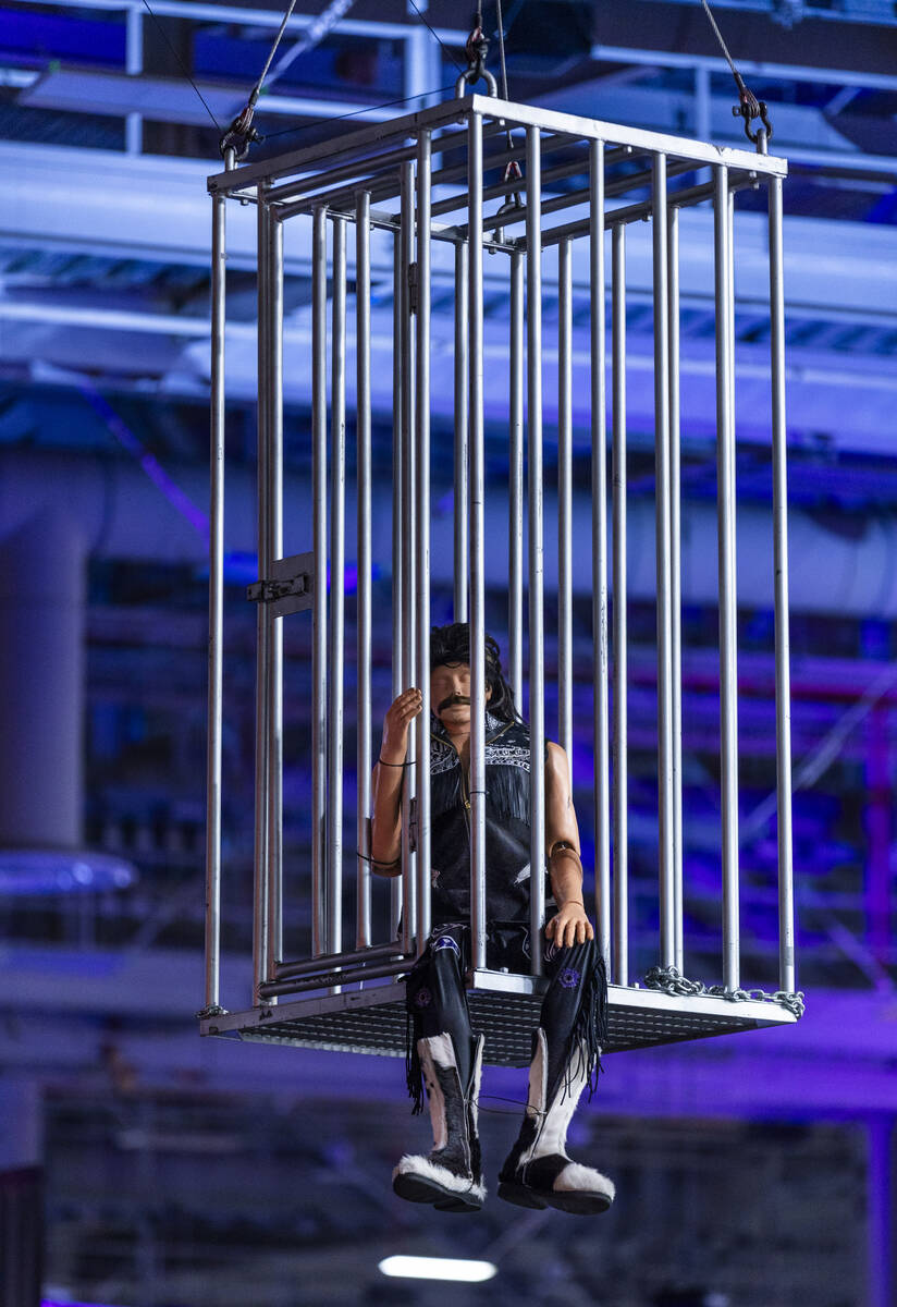 A wrestler mannequin is inside a suspended cage at the WWE World, the Ultimate Fan Experience w ...