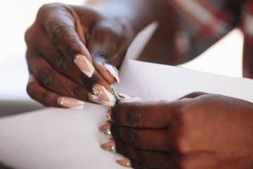 Danielle Carter prepares to show petitions and letters at her home Sunday, April 6, 2025, in La ...