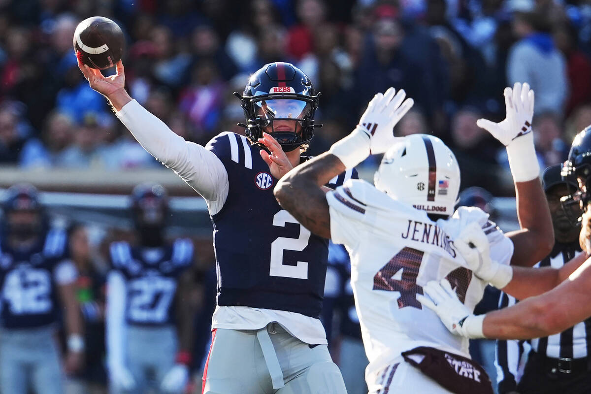 FILE - Mississippi quarterback Jaxson Dart (2) passes while being pressured by Mississippi Sta ...
