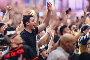 A fan cheers as Dominik Mysterio is declared a winner of an intercontinental championship match ...