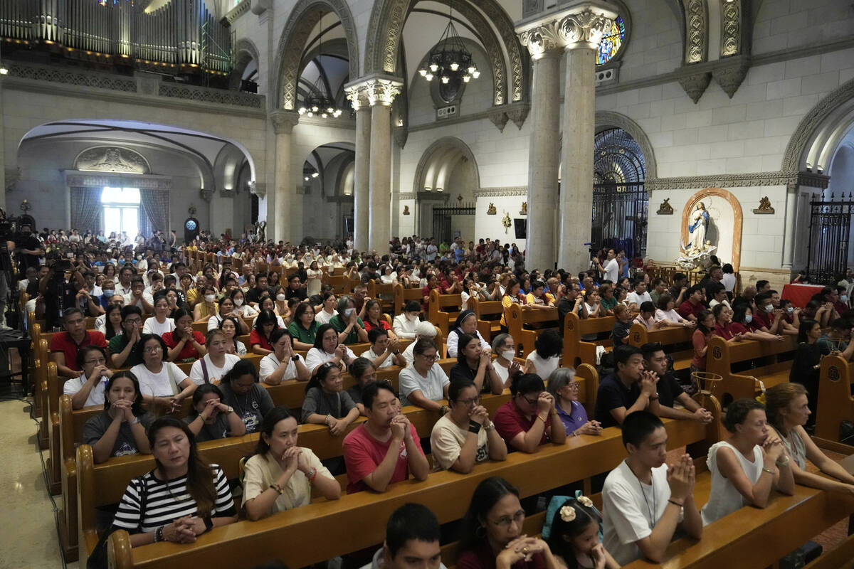 Catholics attend a mass for the late Pope Francis at the Manila Cathedral in the country's capi ...