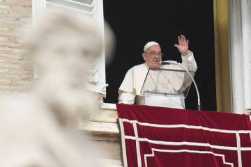Pope Francis waves during the Angelus noon prayer on the occasion of the Epiphany day from the ...