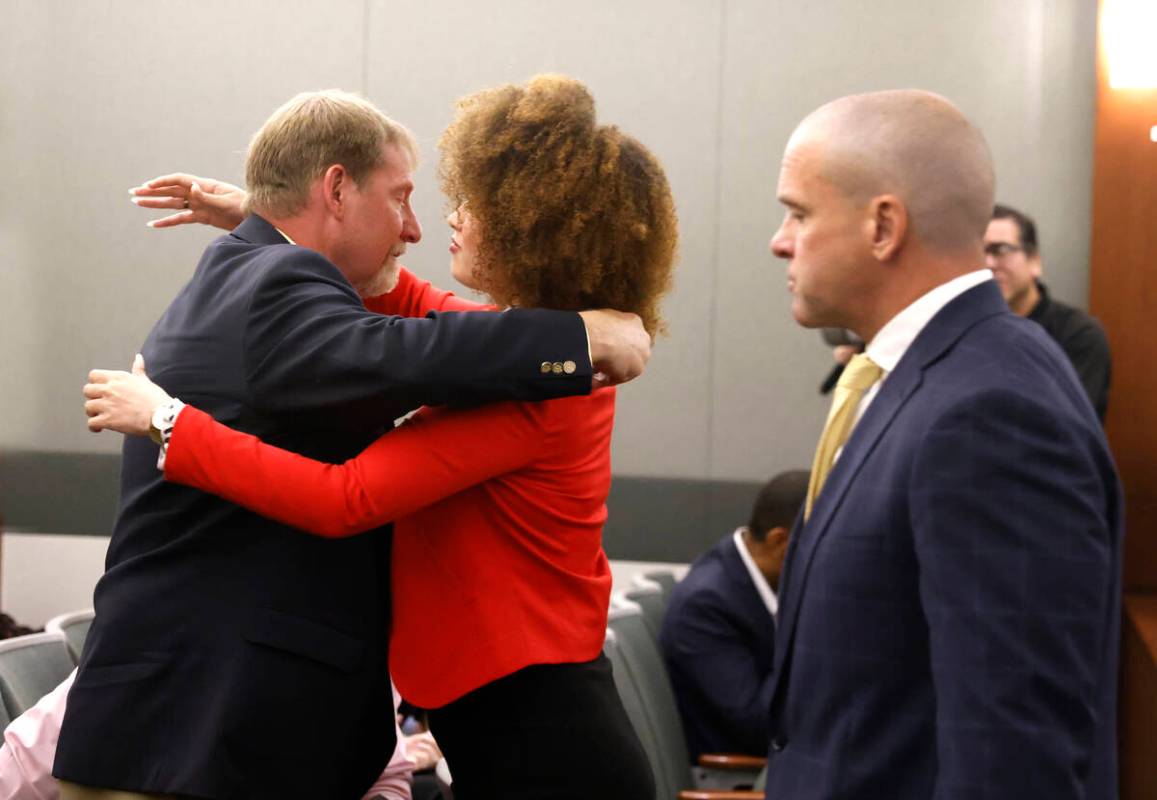 Anna Westby, center, who survived the attack after being stabbed in the back, hugs Vern DiGiova ...