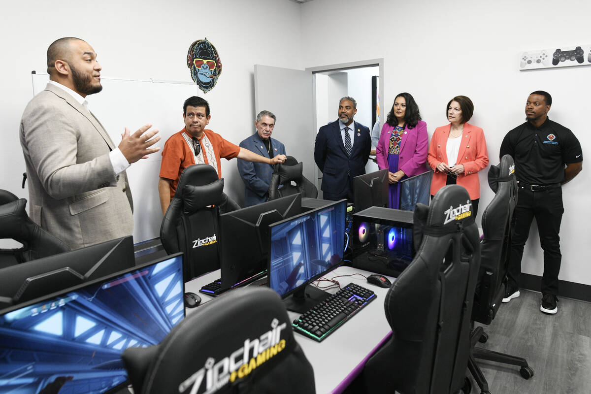 Wilson Ramos, left, describes the computer lab to, from left, North Las Vegas Councilman Isaac ...